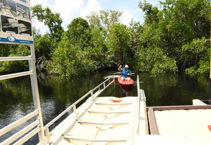 Man entering canoe launch from river water