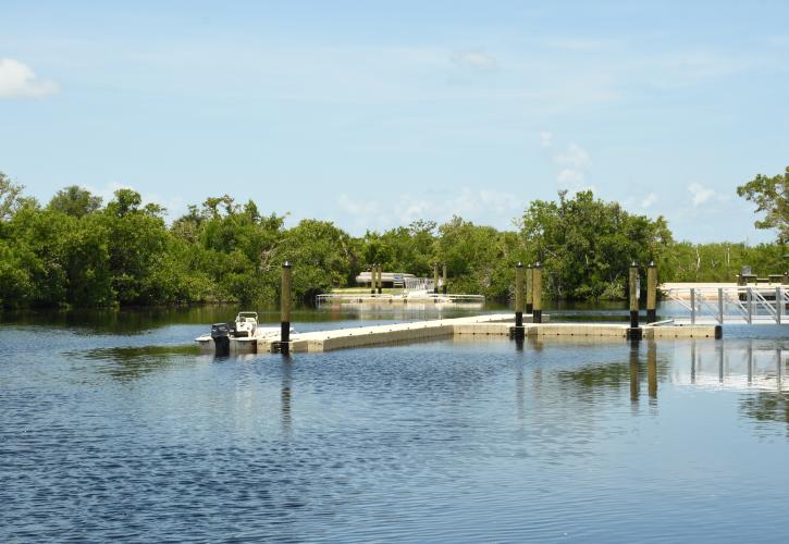 Floating boat dock with boat in water