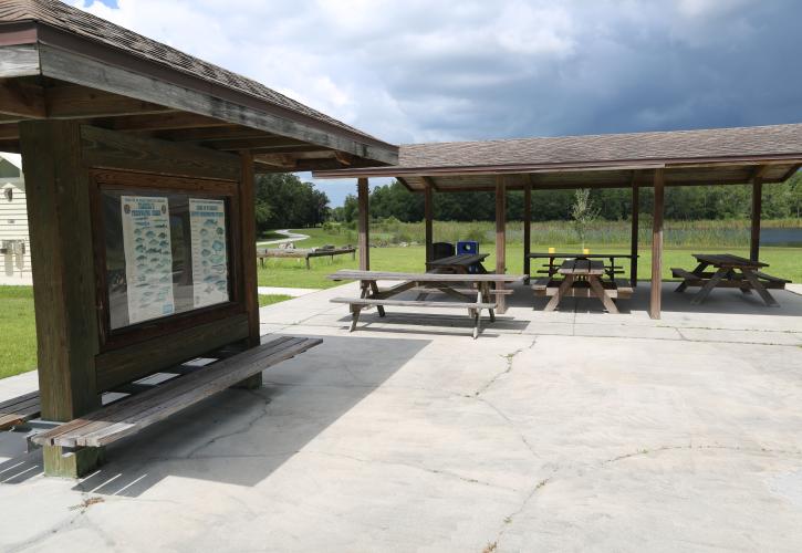 Five wooden picnic tables at Colt Creek