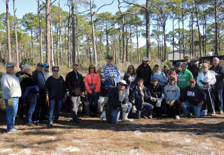 Group of volunteers pose for a photo before venturing around the park collecting debris post Hurricane Michael.