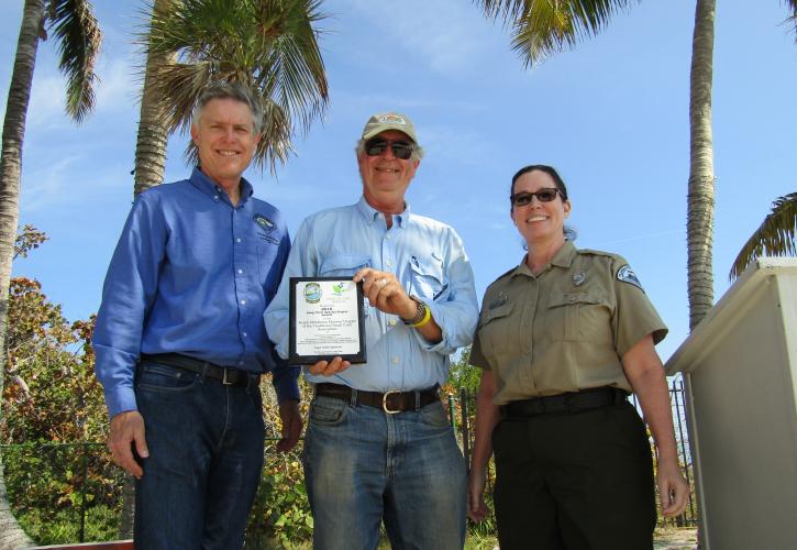 A representative from the Ralph Middleton Munroe Chapter of the TSCA accepting the award.