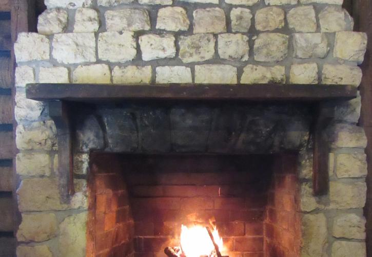 The stone fireplace with a warm, inviting fire