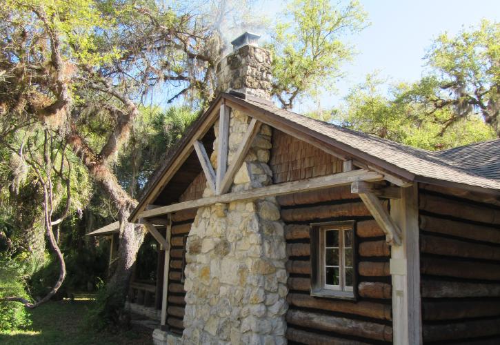 The Log Pavilion shows its handcrafted stone fireplace