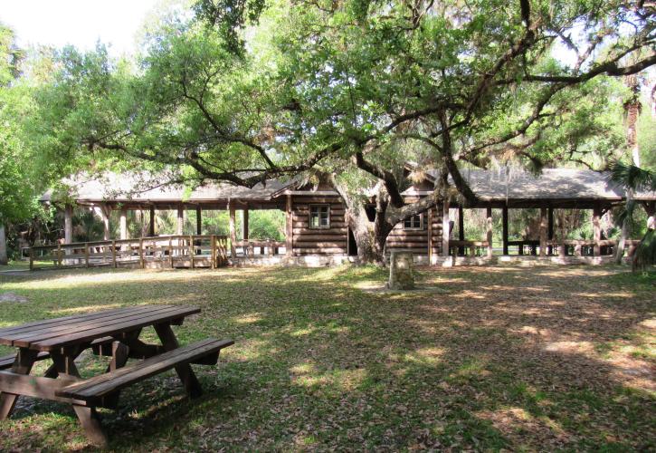 A view of the open area behind the Log Pavilion that leads to the river