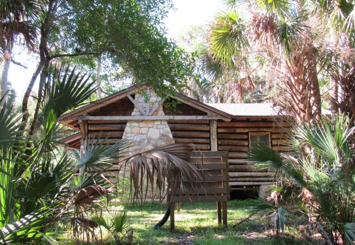 Trees frame the cabin in the hammock