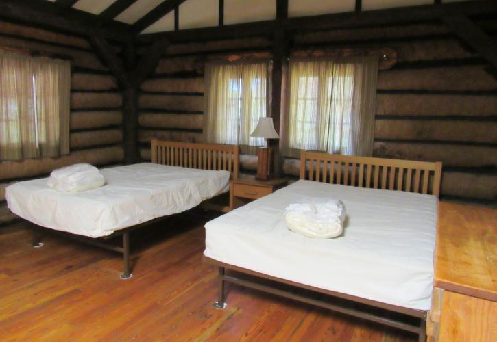 Two double-beds with linens on top