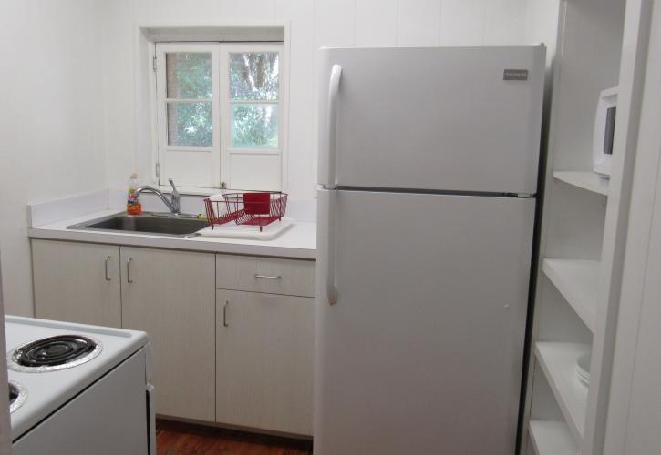 A view of the interior of the kitchen, including a view of the refrigerator and sink
