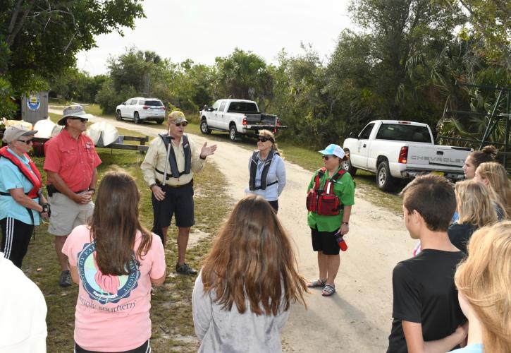 Students being given canoe paddling instructions