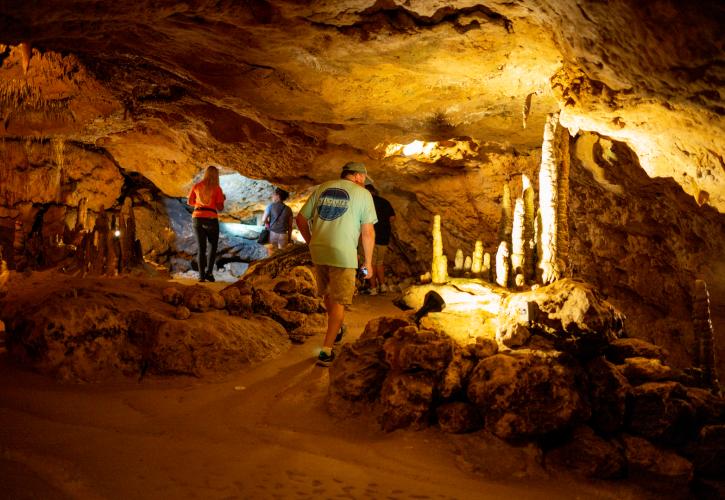 Three people on a cavern tour.