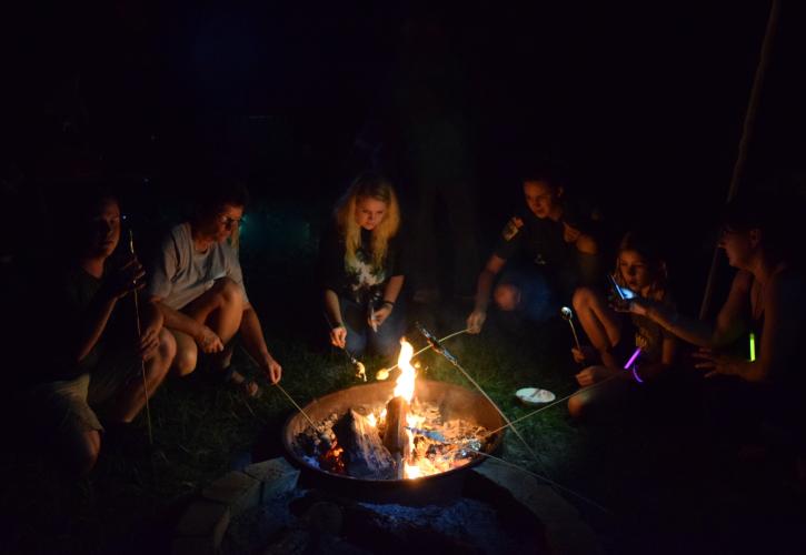 Roasting marshmallows around a campfire