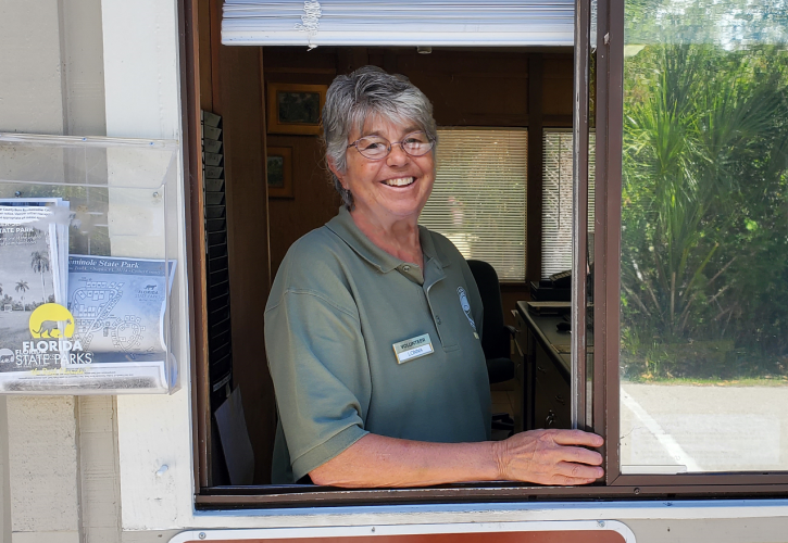 Woman in green shirt at the window of the ranger station