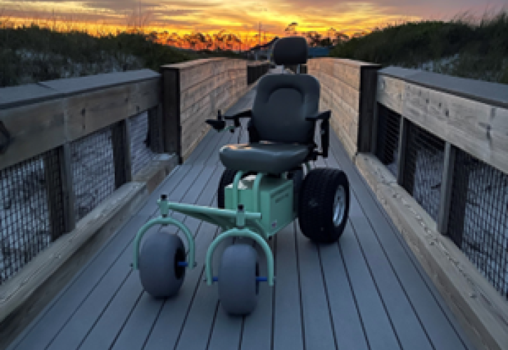 A motorized wheelchair on a boardwalk.