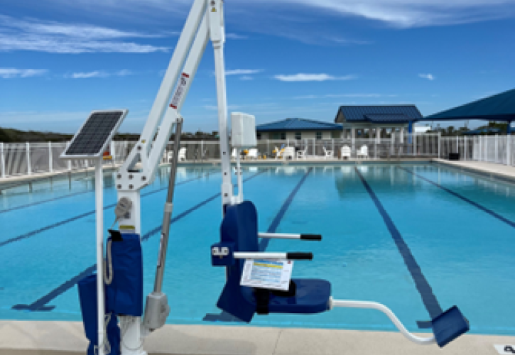 A lift chair next to a pool.