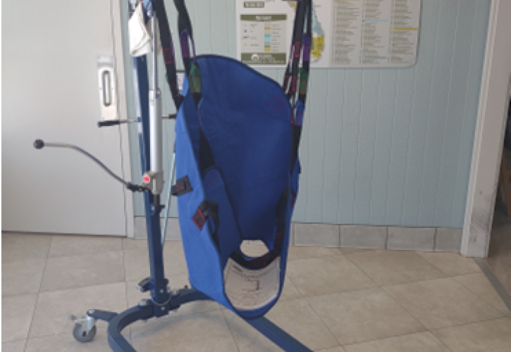 A hoyer lift set up inside of a building.