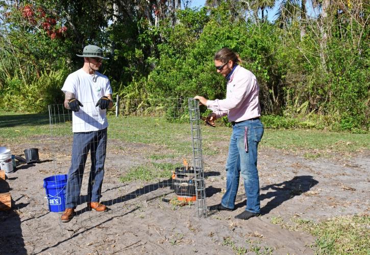 men building a garden plant trellis