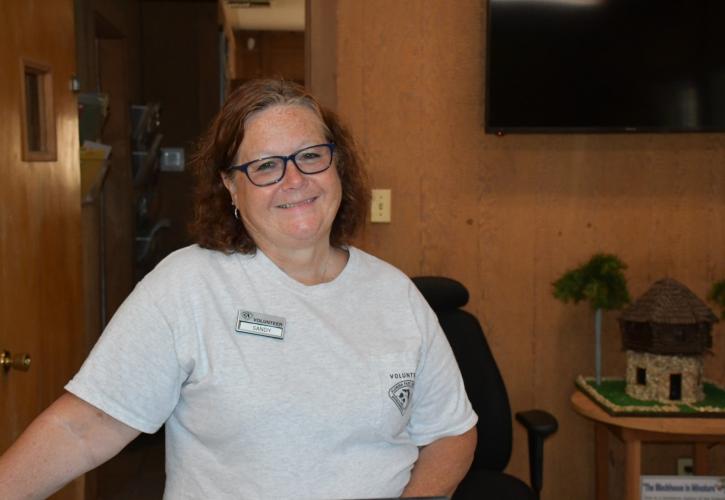 Woman smiling in a park office.