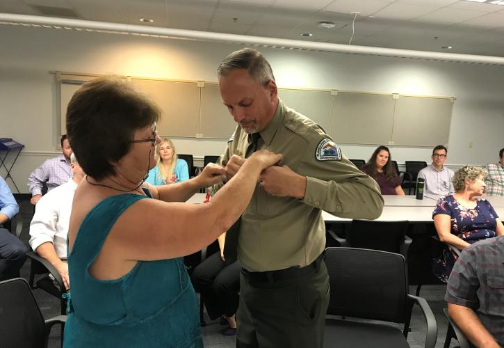 Scott Spaulding receiving pin from wife