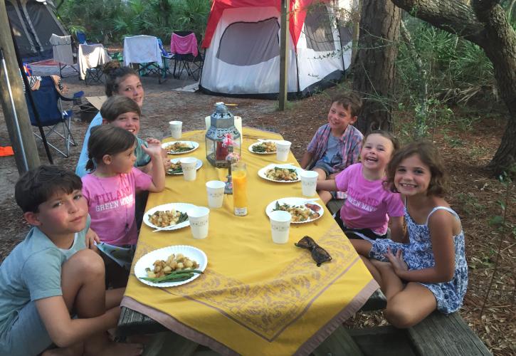 Kids enjoying a picnic at a campsite table