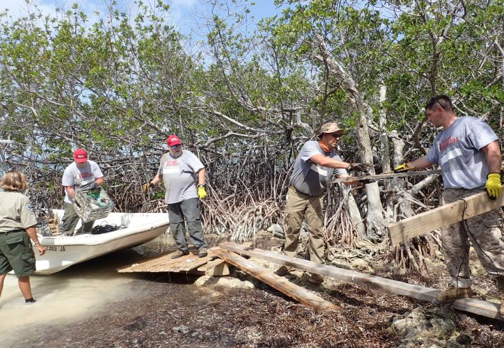 Team Rubicon Members removing trash from island
