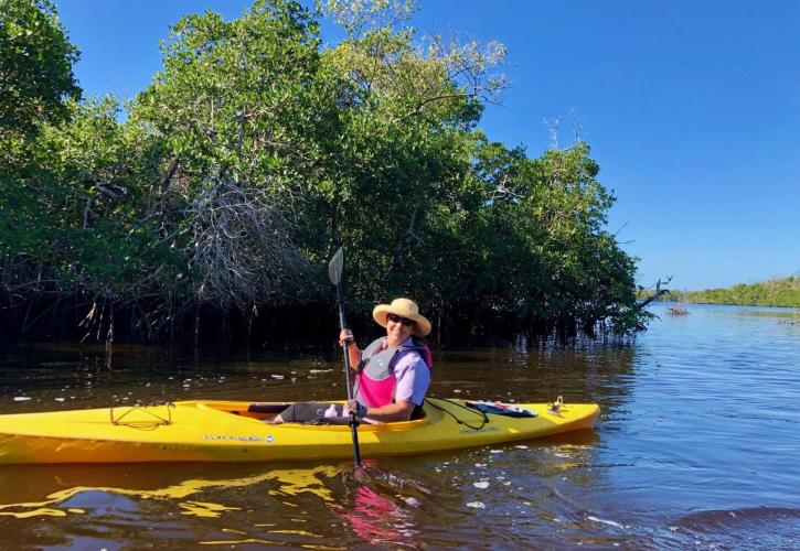 Woman paddling in a canoe on a river