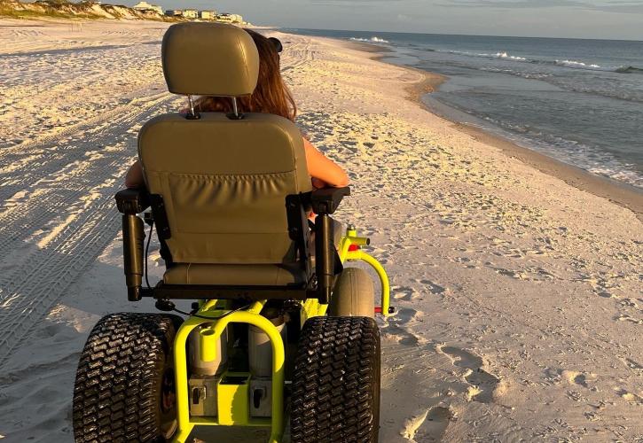 A photo of a motorized wheelchair on the beach