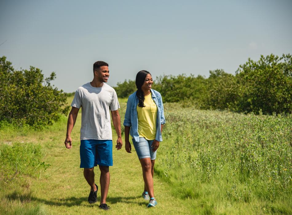 A couple hiking down a trail.