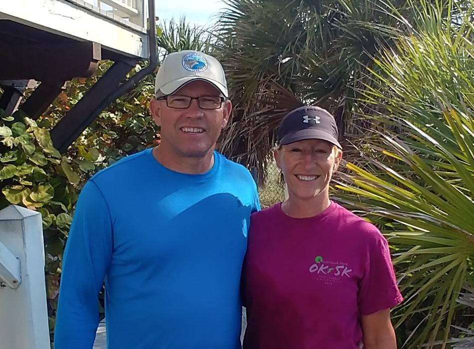 Two volunteers standing and smiling