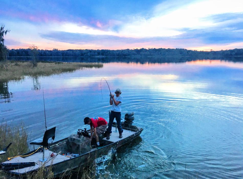 Two people fish for bass at Paynes Prairie Preserve State Park.