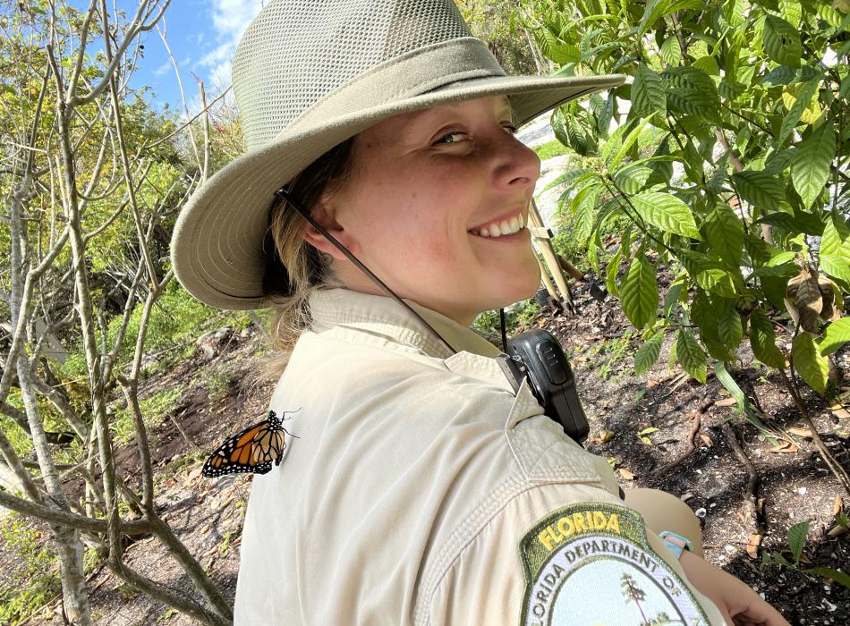 A butterfly has landed on Anna's shoulder.