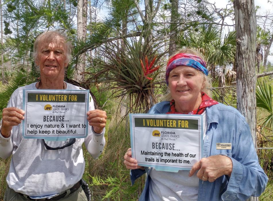 two people holding signs