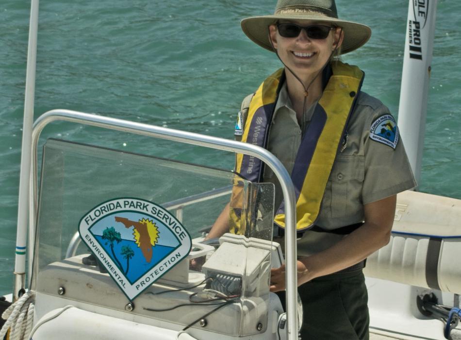 Becky Collins at the helm of a boat.