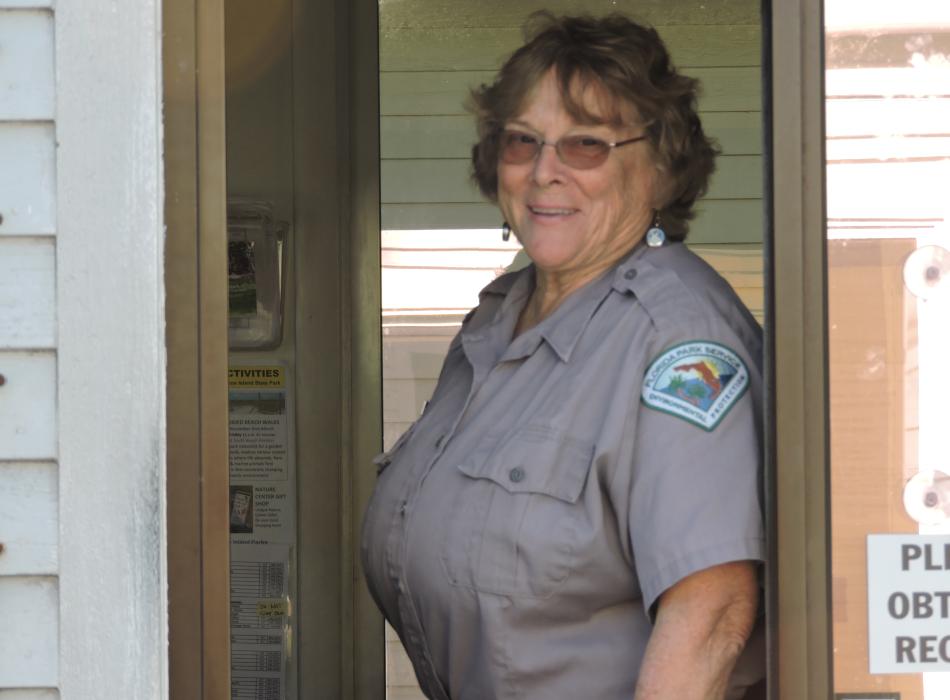 Dorothy Stevens, smiling at the camera, wearing her volunteer uniform.