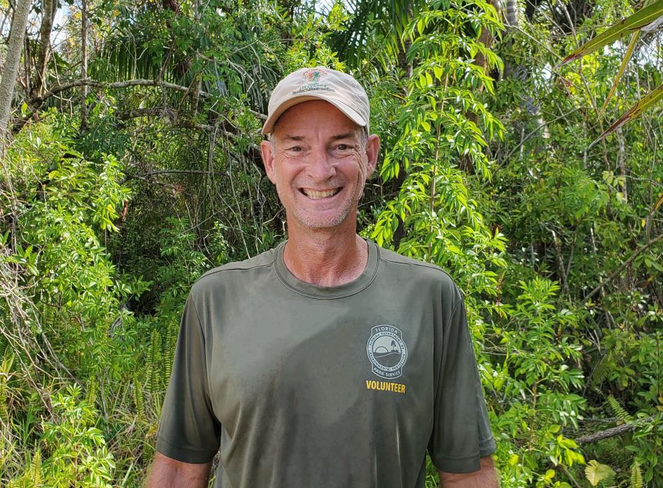 person wearing a hat and green shirt