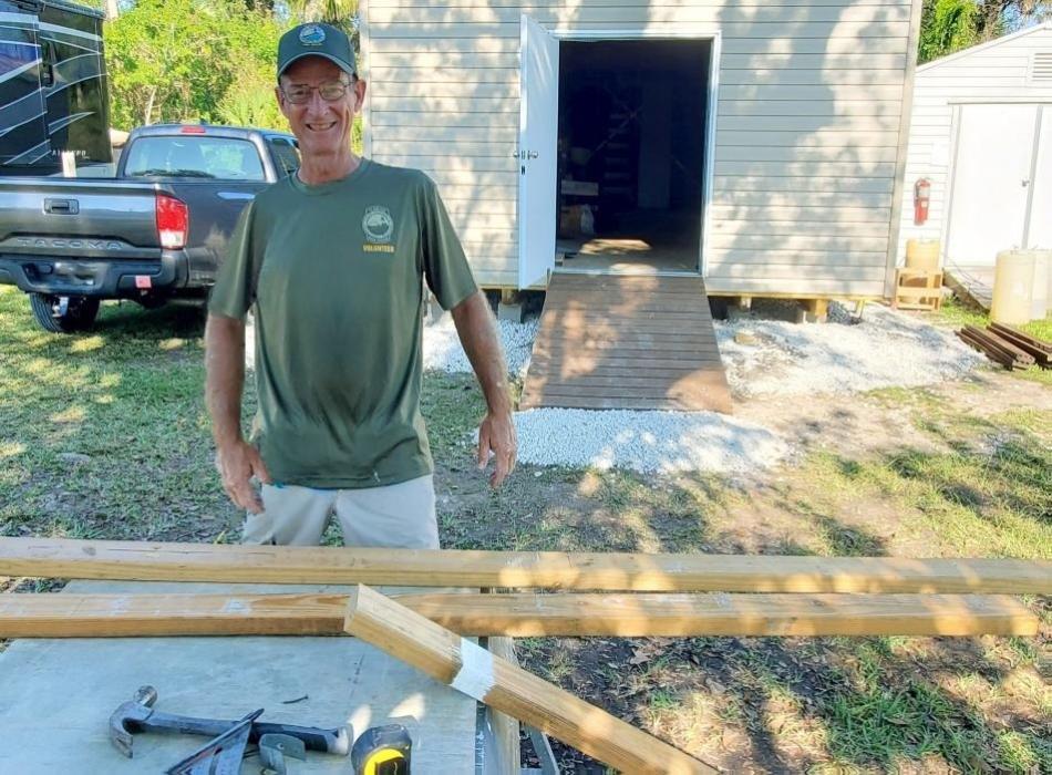 Man standing wearing green shirt 