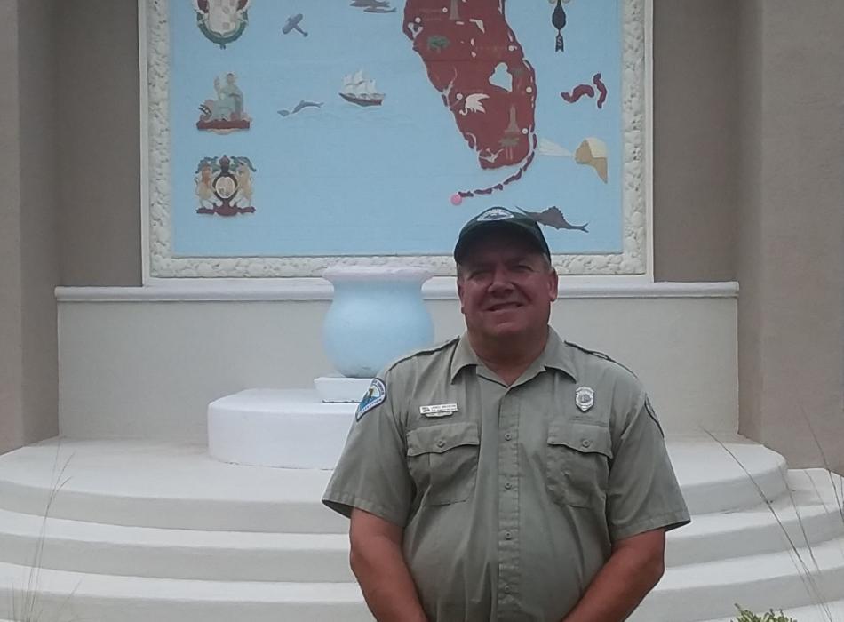 Jim, standing in front of a fountain with a map of Florida over it.