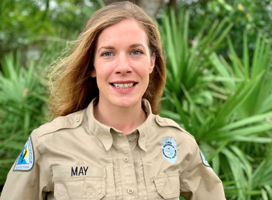 Emily May, smiling at the camera, wearing her uniform.