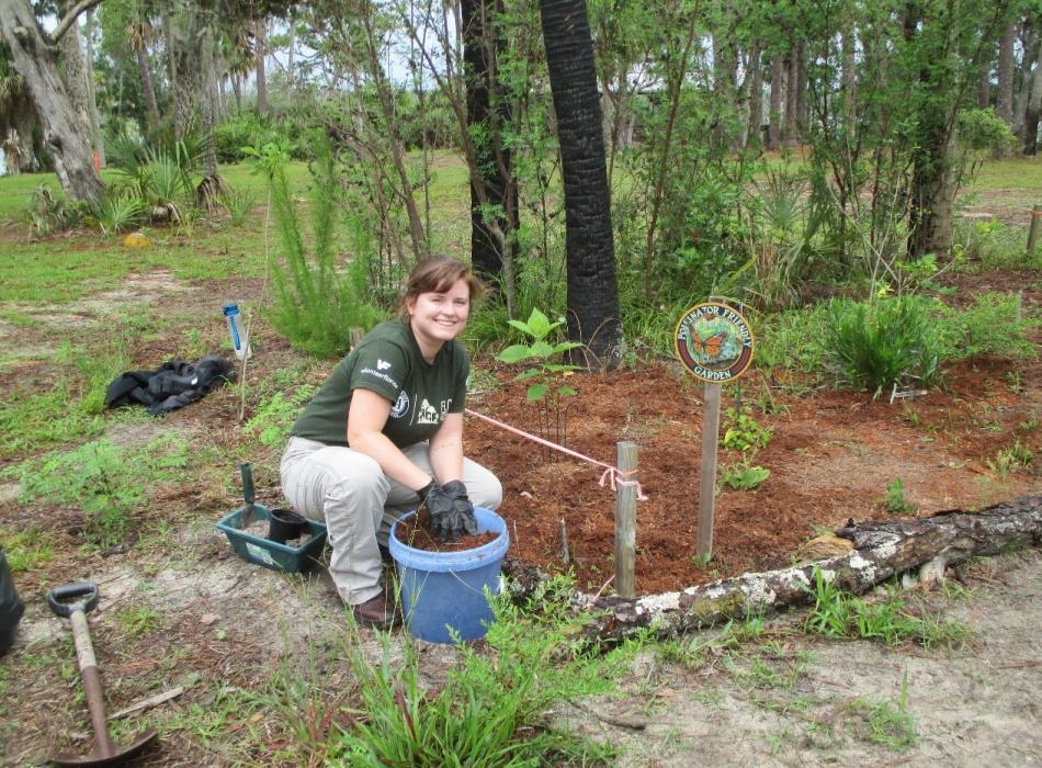 Etta mulches a pollinator-friendly area.