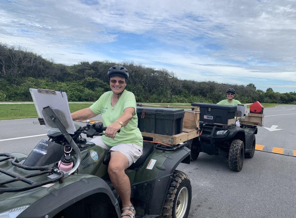 Volunteers Maryann Andreychak and Debbi Black ride park service ATVs to monitor sea turtle nests