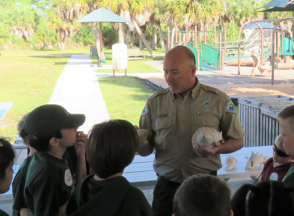 Todd Andrews, speaking to a small group of people.