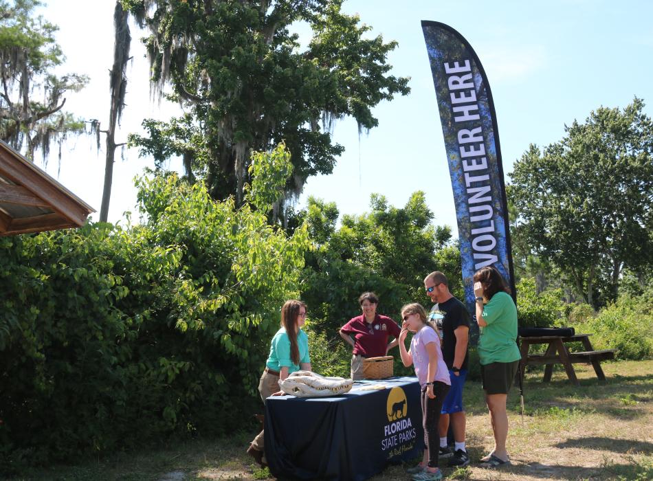 Girl Scouts talk with park staff about volunteer opportunities.