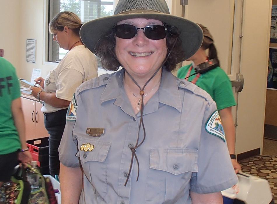 Mary, smiling at the camera in her volunteer uniform.