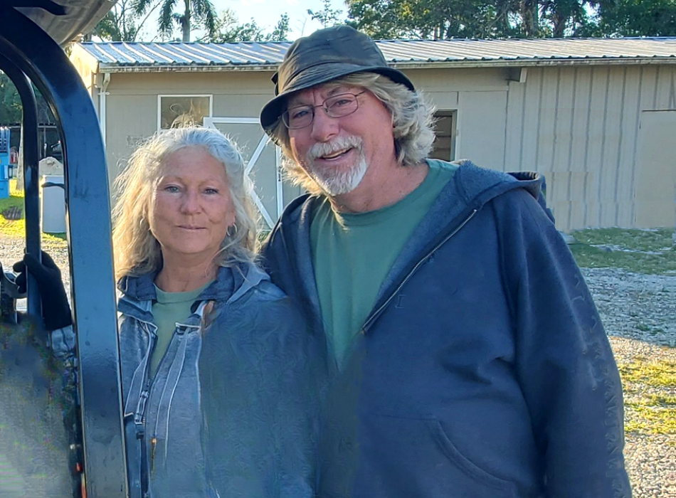 two people standing together wearing blue clothes