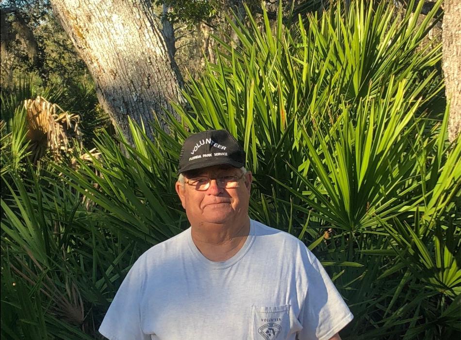 Jim Murphy standing in front of saw palmetto at Faver-Dykes State Park 