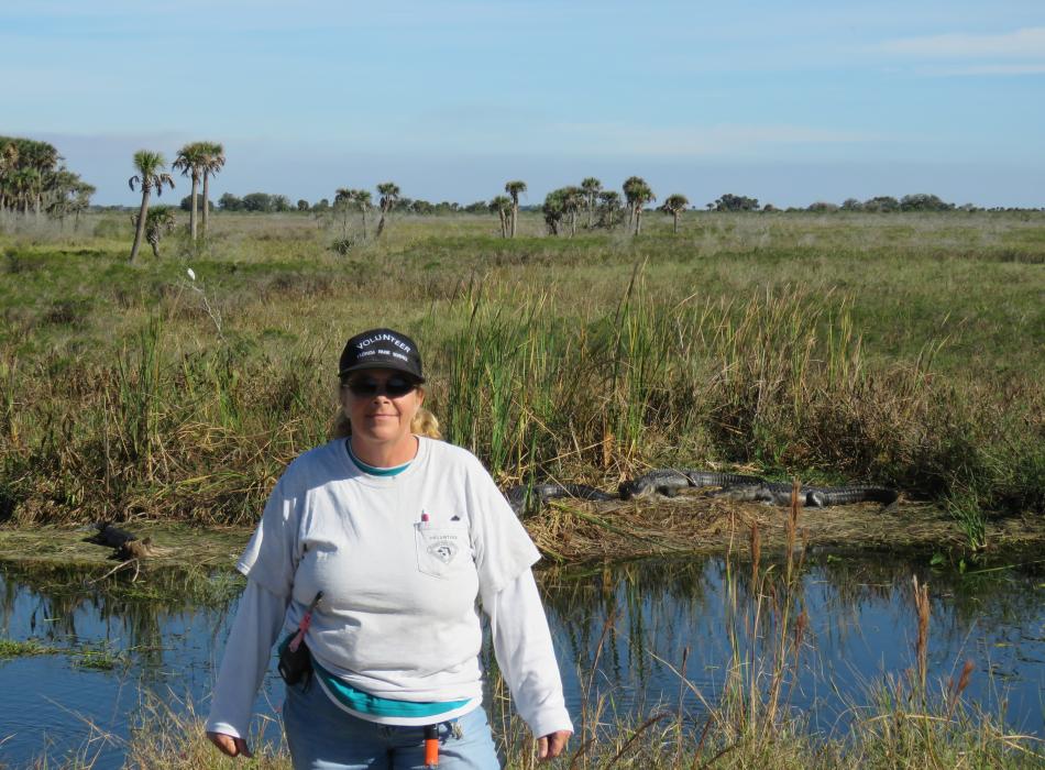 Joan, standing in front of a lake.