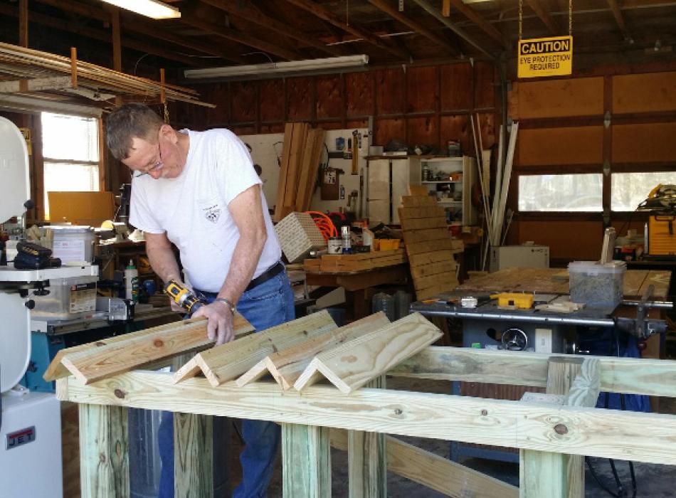 a man uses a table saw in a workshop