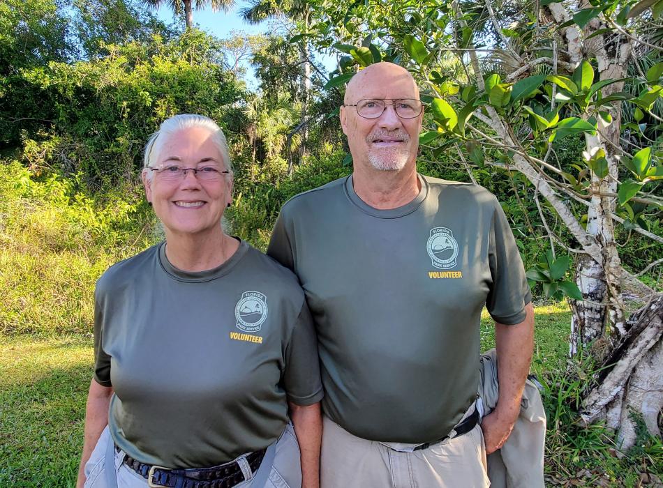 Two people wearing green shirts