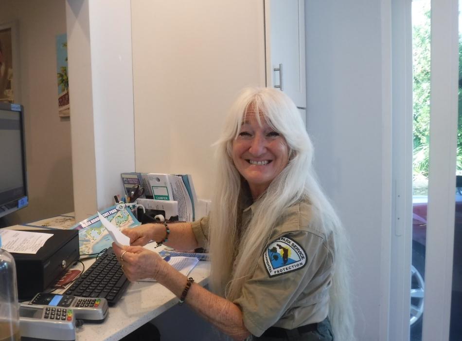 Mona McCauley, wearing her ranger uniform, smiling at the camera.