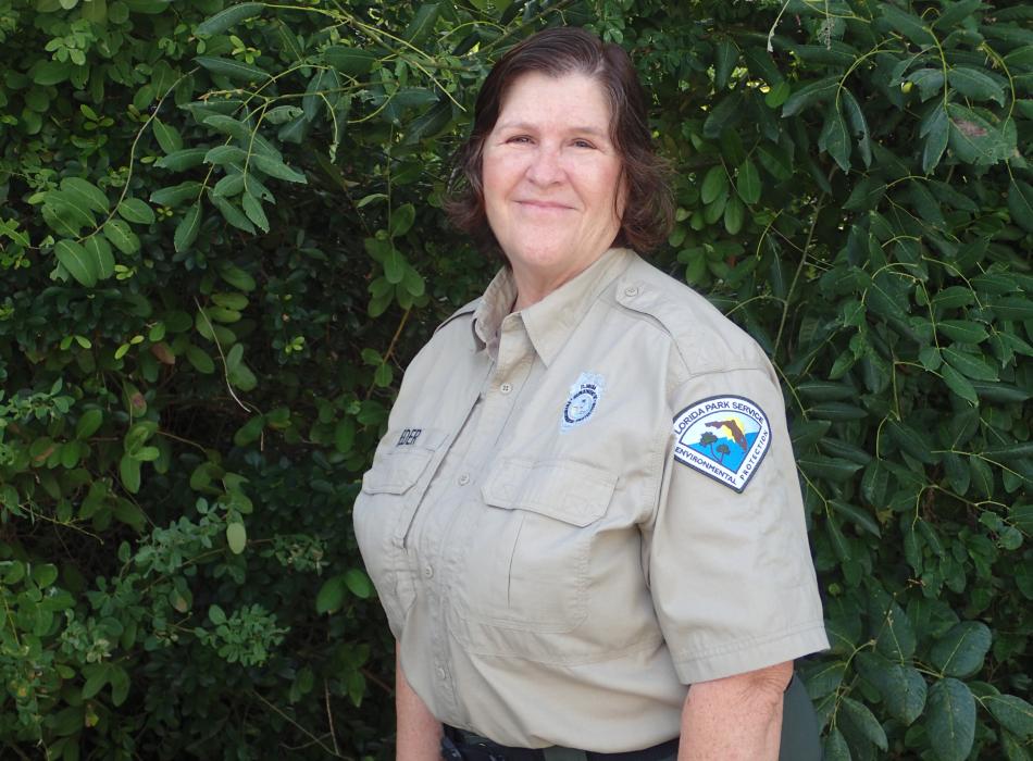 Mary Ann Rieder in front of foliage