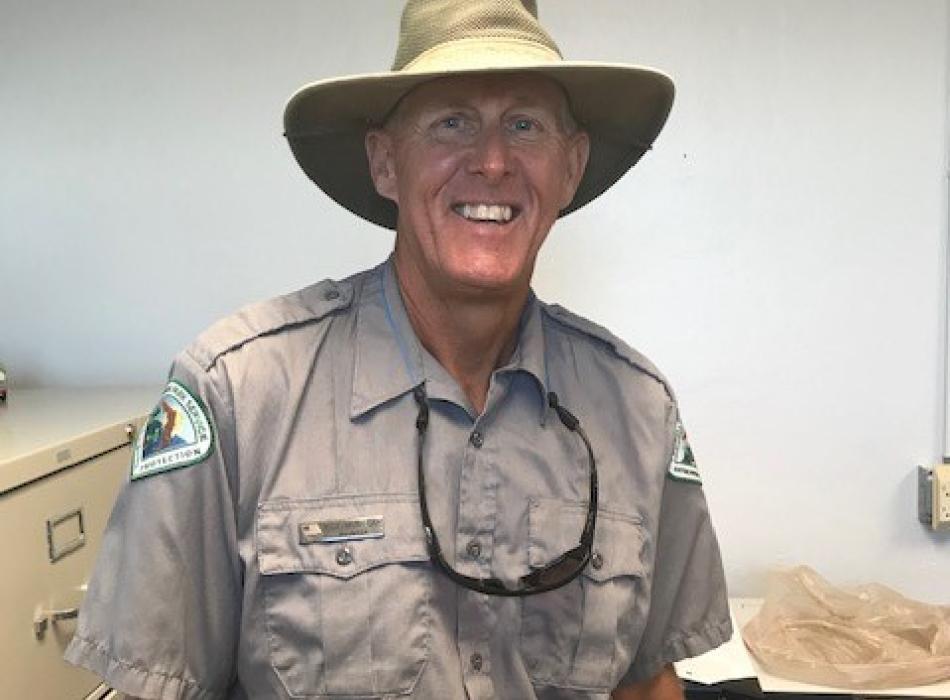 Rick Mungeam, smiling at the camera, wearing his ranger uniform.