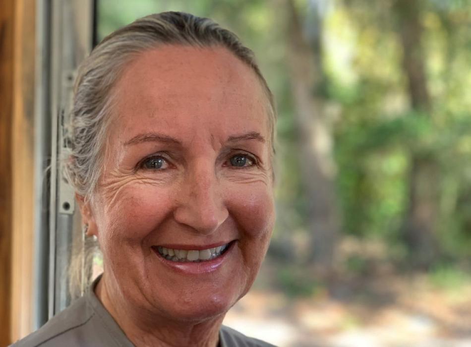 woman smiling brightly at fort clinch state park.